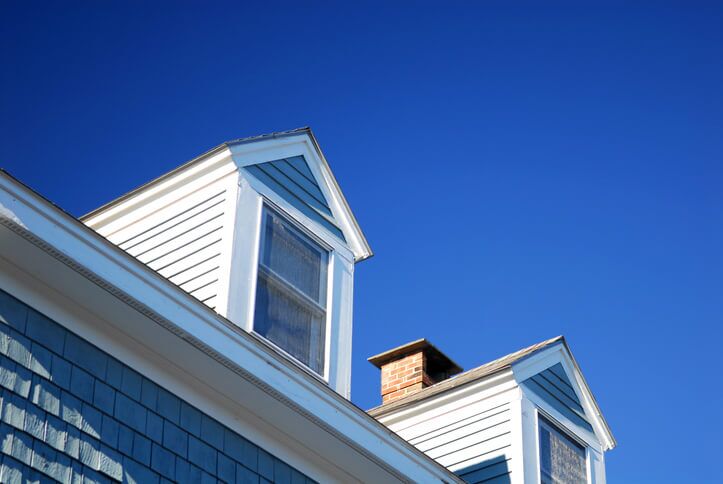 Modern blue and white house roof against clear blue sky