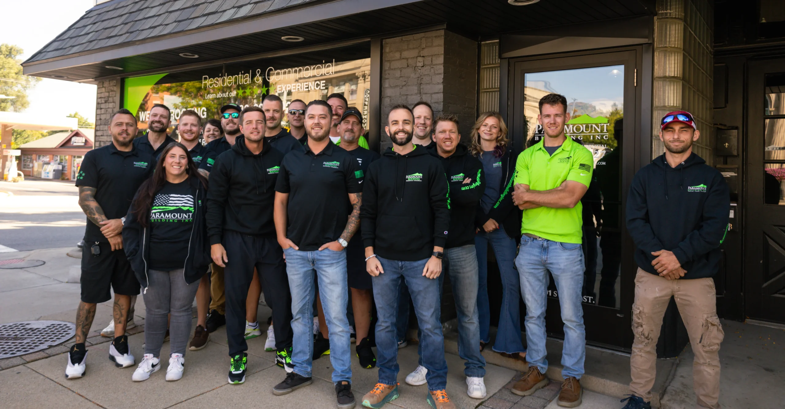 Paramount Siding team group photo outside company storefront with employees