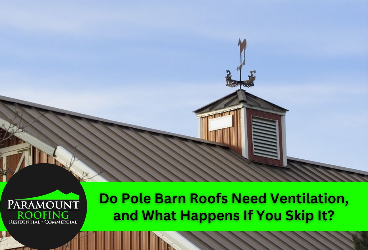 Pole barn roof with ventilation and weather vane under clear sky.