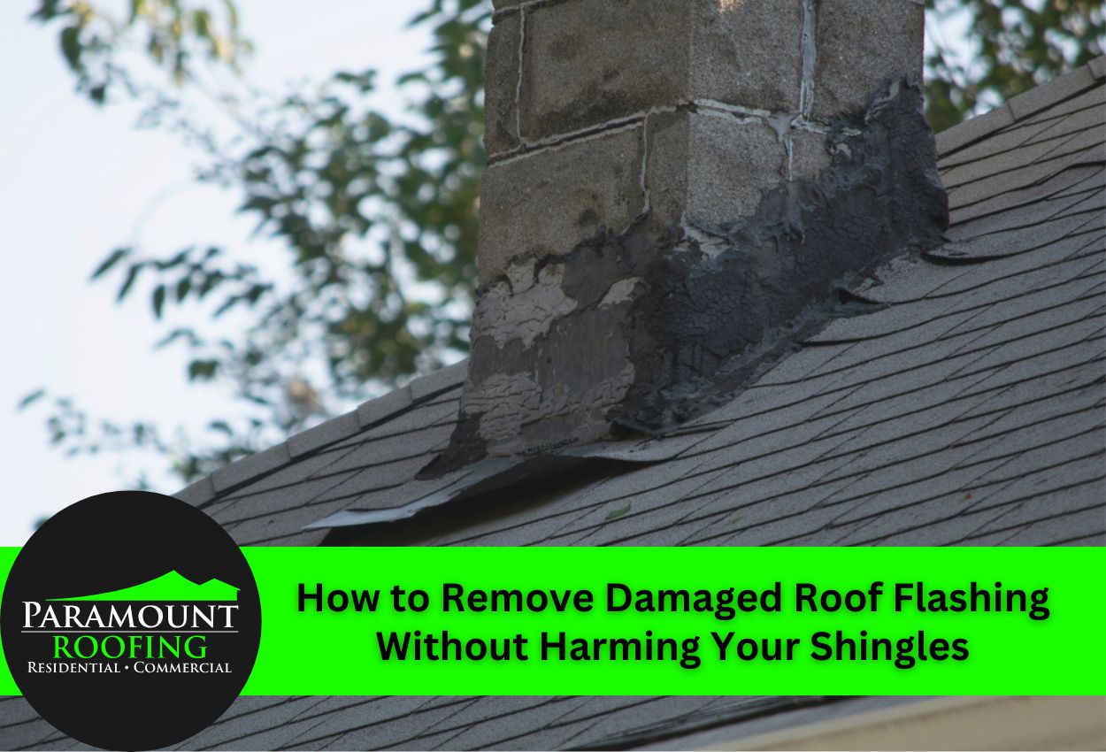 Close-up of damaged roof flashing on a chimney with surrounding shingles.