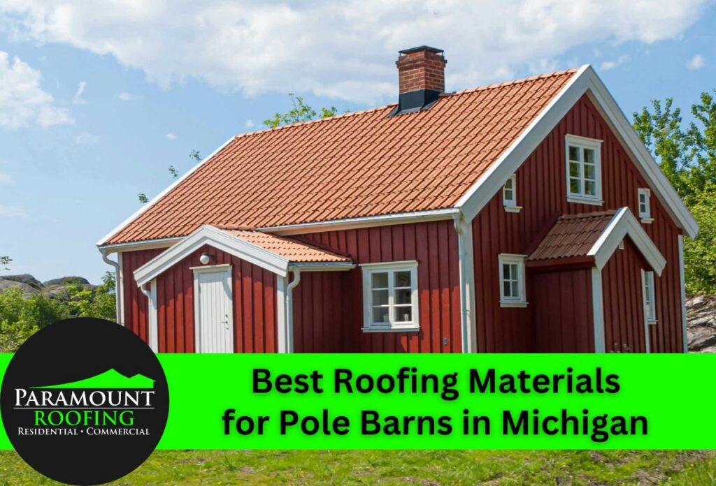 Red pole barn with a metal roof surrounded by greenery under a blue sky.